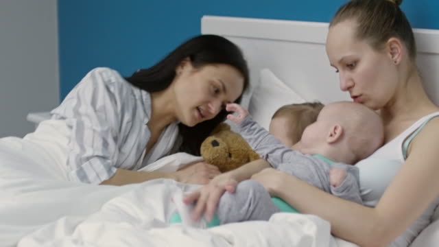 Female-Couple-Playing-with-Children-in-Morning