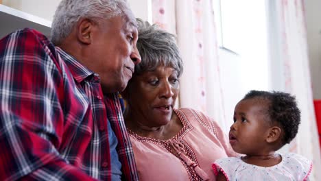 Grandparents-singing-to-baby-granddaughter-at-home---shot-in-slow-motion