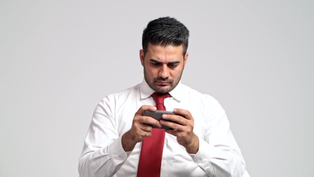 Businessman-playing-mobile-phone-games-during-office-hour.