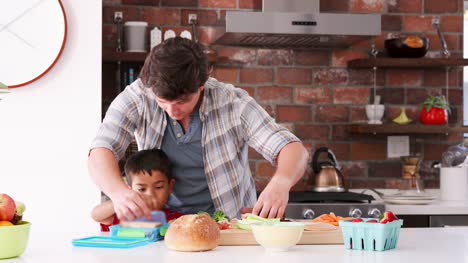 Father-And-Son-Making-Sandwiches-For-Packed-Lunch-In-Kitchen