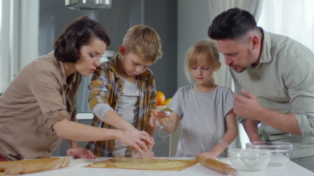 Kids-Cutting-Cookie-Dough-with-Help-of-Parents