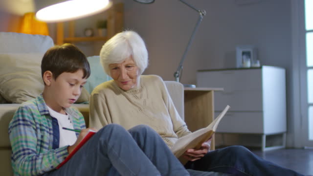 Grandma-and-Schoolboy-Reading-Textbook