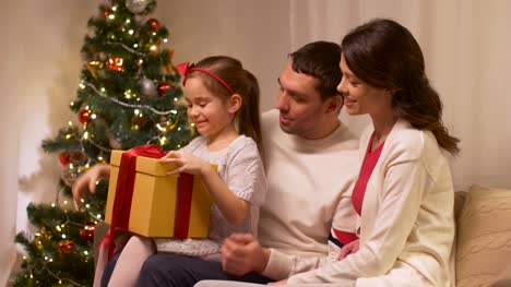 happy-family-with-christmas-present-at-home