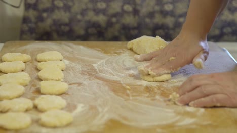Making-dough-pieces-with-woman's-hands-at-home.
