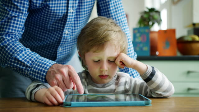 Vater-mit-Sohn-wie-Digital-Tablette-verwenden