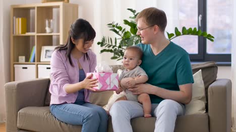 happy-family-with-gift-and-baby-boy-at-home