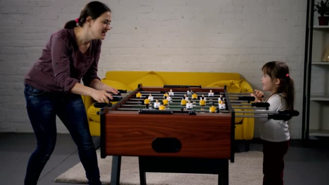 Mom-and-special-needs-child-enjoying-table-soccer