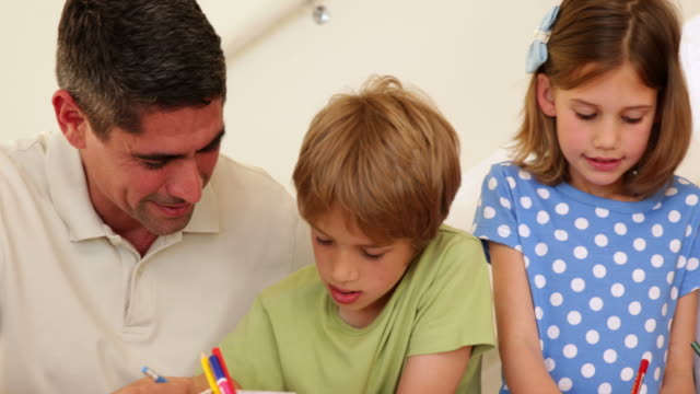 Cute-parents-and-children-colouring-together