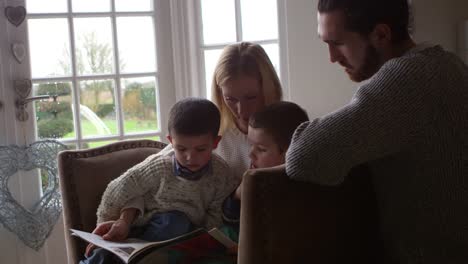 Family-Sits-In-Chair-And-Reads-Book-Together-Shot-On-R3D