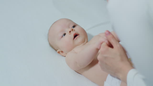 Parent-Holding-Newborns-Hand