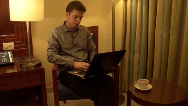 Man-using-laptop-in-home-interior.