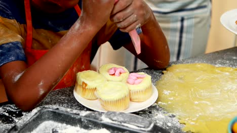 Mid-section-of-boy-preparing-cupcake-4k