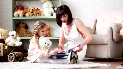 Mother-and-daughter-reading-a-book,-playing,-having-fun,-hugging,-together,-4k