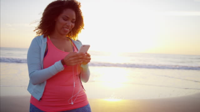 Plus-size-Ethnic-female-texting-with-smart-phone