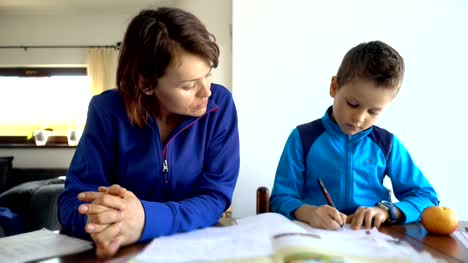 Mother-and-child-doing-school-homework,-4K-resolution