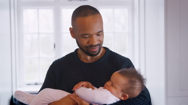 Nuevo-padre-abrazando-a-dormir-niña-en-guardería-en-el-hogar