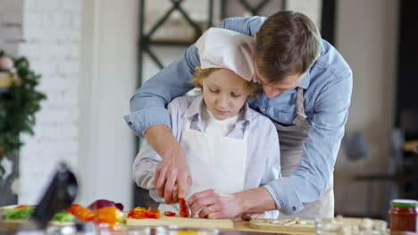 Boy-Learning-to-Cut-Food-with-Father