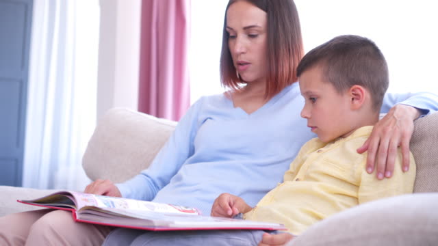 Caring-mom-and-son-reading-book-together