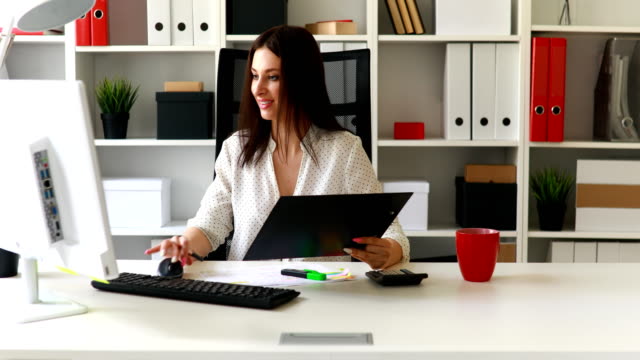 brunette-businesswoman-working-with-documents-in-light-office