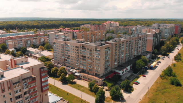 Flying-above-old-construction.-AERIAL:-Flight-over-dormitory-area-under-clear-blue-sky.-Summer-sunny-day.-Building-with-apartments.-Drone-view.-HD-footage