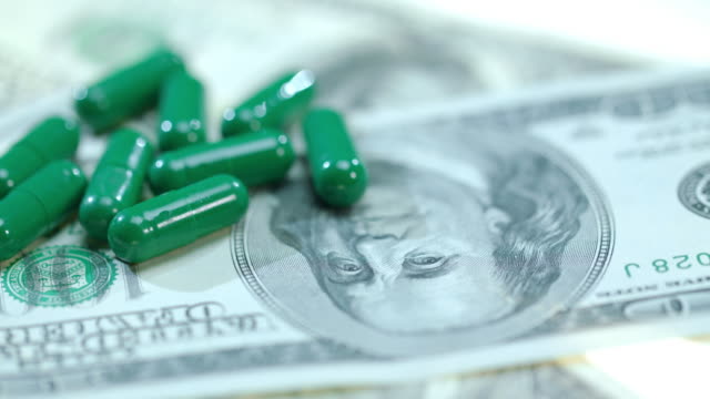 Medical-capsule-on-dollar-banknote.-Herbal-capsules-on-money-cash