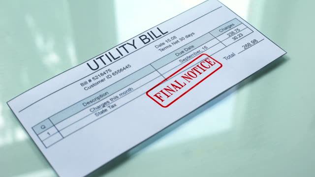 Utility-bill-final-notice,-hand-stamping-seal-on-document,-payment-for-services