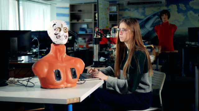 Obere-Hälfte-ein-Cyborg-Körper-und-eine-junge-Frau,-die-einen-Laptop-in-Betrieb