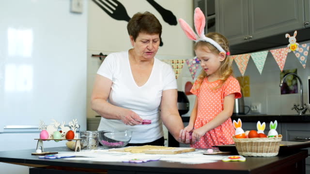 Grandma-and-Granddaughter-Baking-Easter-Cookies