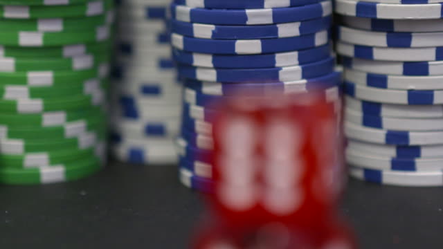 Two-red-dice-on-the-background-of-the-poker-game