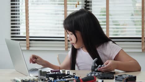 Little-girl-working-at-laboratory-alone,-Assembling-and-Testing-to-equipment-in-workshop.-People-with-technology-and-innovation-concept.