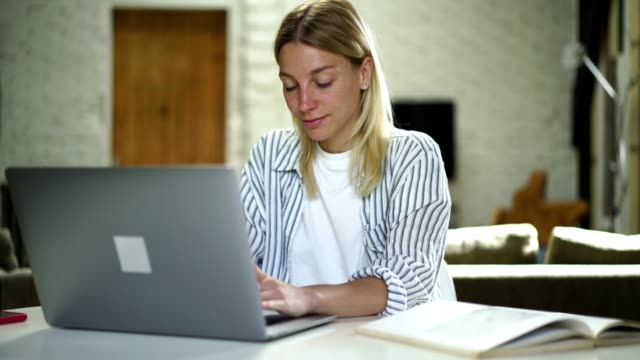 Intelligent-hipster-girl-keyboarding-on-laptop-computer-sending-messages-in-social-networks