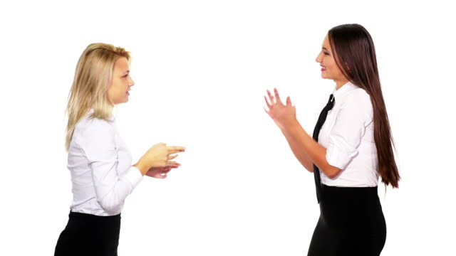 Two-female-colleagues-talking-when-a-male-colleague-with-a-smart-phone-passes-by