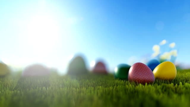 Colorful-Easter-eggs-on-green-meadow-over-bright-sun