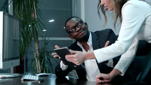 Afro-american-boss-satisfied-with-the-job-of-his-asian-colleague