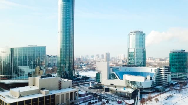Top-view-of-the-modern-city-in-winter.-Beautiful-Sunny-day-in-the-big-city-with-a-skyscraper-in-the-winter