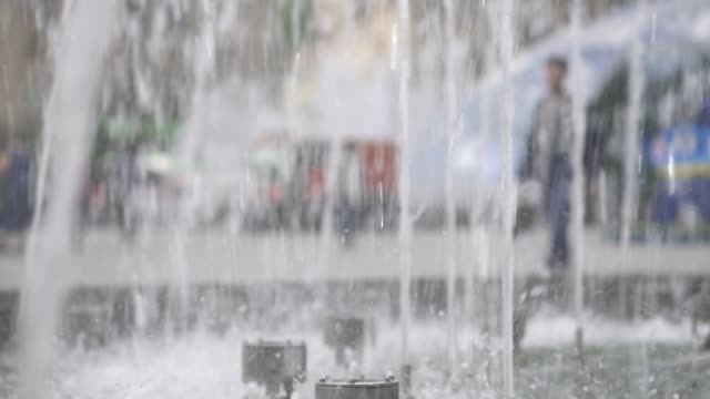 The-fountain-in-the-city-is-close-up.-Water-jets-slowed-down.-City-street-summer