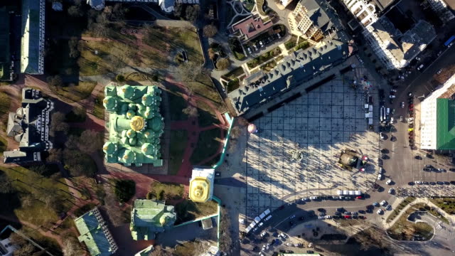 A-bird's-eye-view,-panoramic-video-from-the-drone-in-FullHD-to-the-Saint-Sophia's-Cathedral,-Sofiyivska-Square,-Kiev,-Ukraine.-People-on-the-square-on-Easter-days.-Dolly-out-motion.
