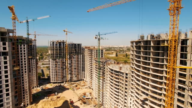 Construction-of-houses.-Drone-fly-over-construction-site-with-tower-cranes