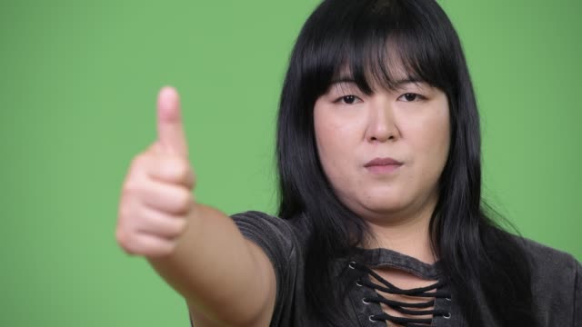 Happy-overweight-Asian-woman-giving-thumbs-up