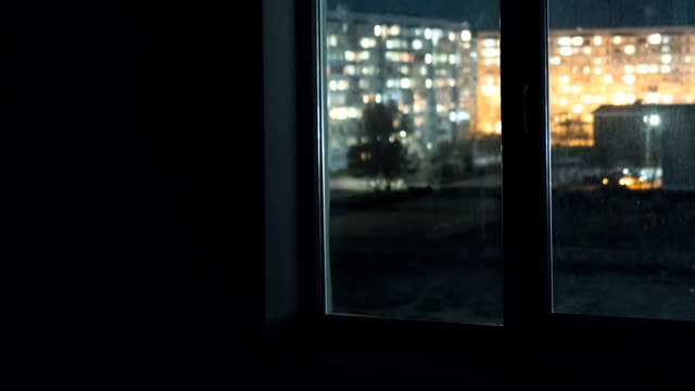 View-through-the-Window-at-the-Lights-the-Windows-in-High-rise-Buildings-at-Night