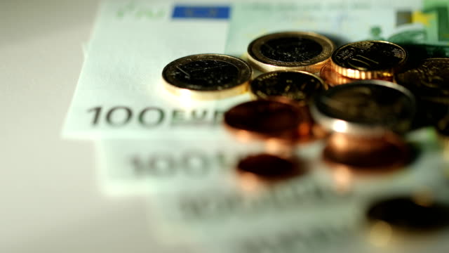 Euro-Bills-Spinning.-Close-Up-Of-Money.-Euro-currency.-Coins-stacked-on-each-other-in-different-positions.-Money-concept.