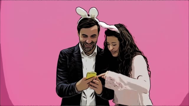 Young-lovers-couple-on-pink-background.-With-ravenous-ears-on-the-head.-During-this-Easter-photo,-I-made-sephi-on-my-phone-and-looked-at-them-laughing.-Animation.