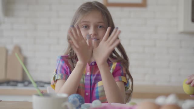 Porträt-lustige-niedliche-emotionale-kleine-Mädchen-zeigt-Hände-in-der-blauen-Farbe