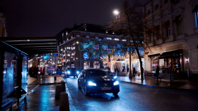 New-Year's-city-with-luminous-colorful-houses,-trees-and-with-cars-on-the-road