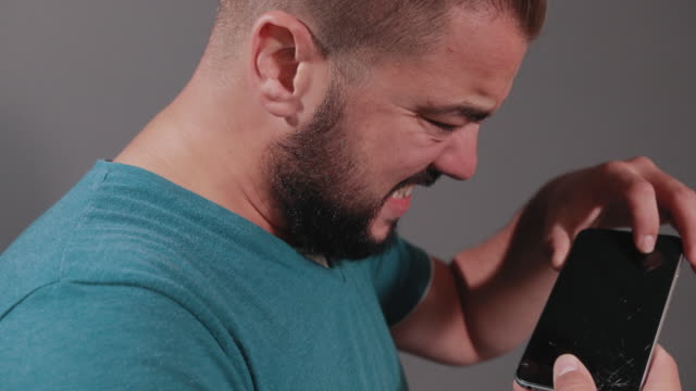 man-holding-smartphone,-falls-phone-from-hands-of-floor,-screen-breaks