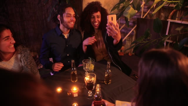 Close-up-black-couple-taking-selfie-with-smartphone-on-patio