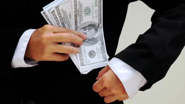 businessman's-hands--Holding-hundred-dollar-bills