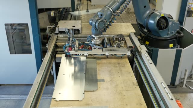 Robot-arm-in-a-metal-factory-picks-up-metal-plates