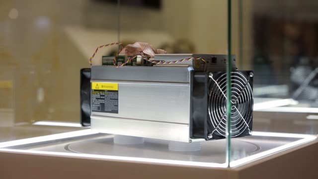 Cryptocurrency-mining-equipment---ASIC---application-specific-integrated-circuit-on-farm-stand-at-expo-or-exhibition