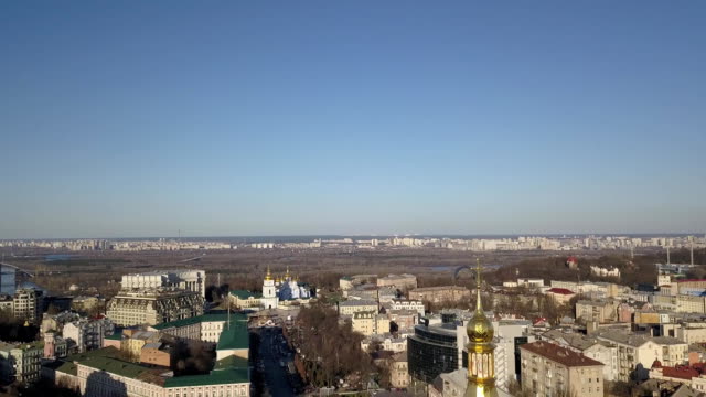 A-bird's-eye-view,-panoramic-video-from-the-drone-in-FullHD-to-the-Saint-Sophia's-Cathedral,-Friendship-of-Nations-Arch,-Podolsky-Bridge-left-bank-of-city-Kiev,-Ukraine.